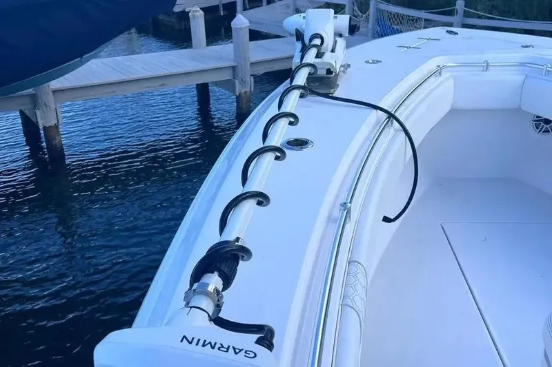 Slide: The Image of 2024 Contender 30 Tournament boat with Garmin equipment docked by the water. - 21