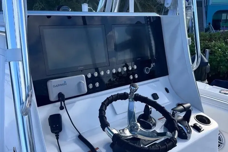 Slide: The Image of 2024 Contender 30 Tournament boat dashboard with Garmin navigation system and steering wheel. - 4