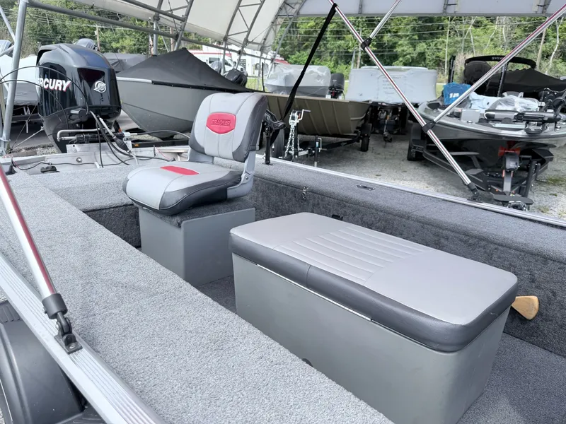 Slide: The Image of The image shows the interior of a 2016 Tracker Panfish 16 boat with gray seating. - 16