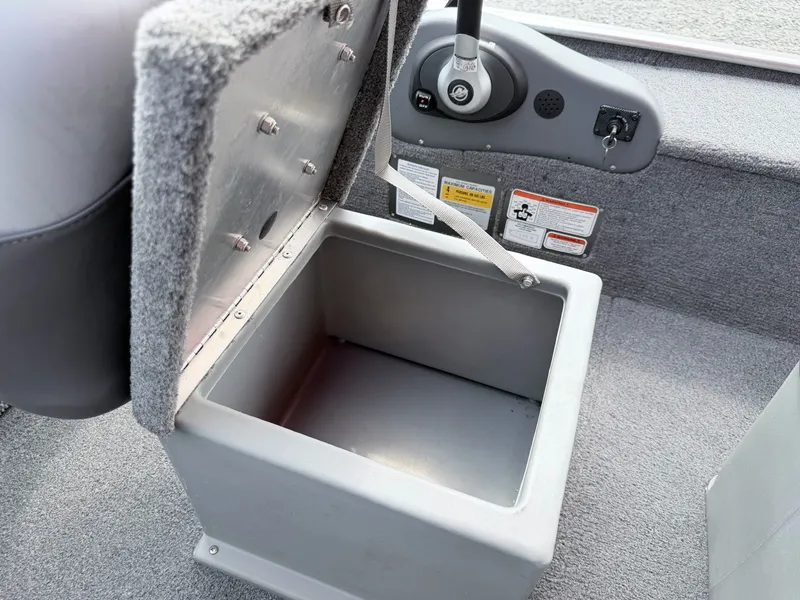 Slide: The Image of An open storage compartment on a 2016 Tracker Panfish 16 boat. - 14