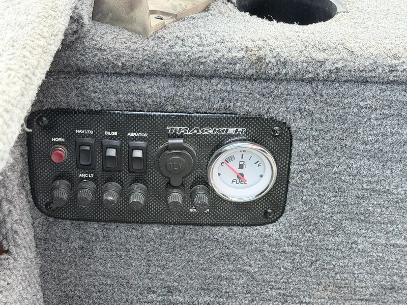 Slide: The Image of A control panel on a boat with switches and a fuel gauge. - 23