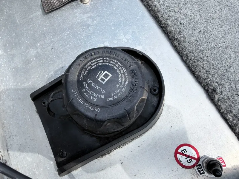 Slide: The Image of Close-up of a black fuel cap on a gray boat floor. - 19