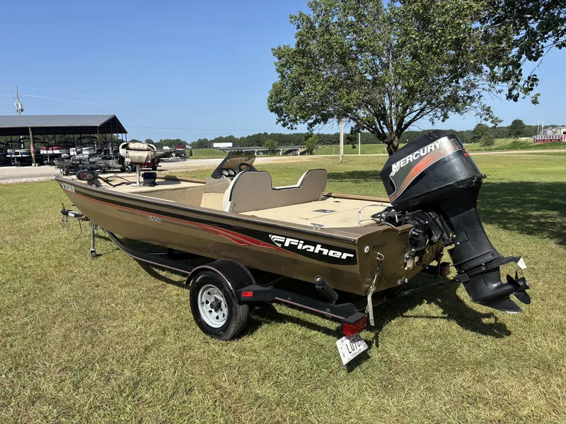 Slide: The Image of A 2006 Fisher boat with a Mercury outboard motor sits on a trailer in a grassy area. - 9