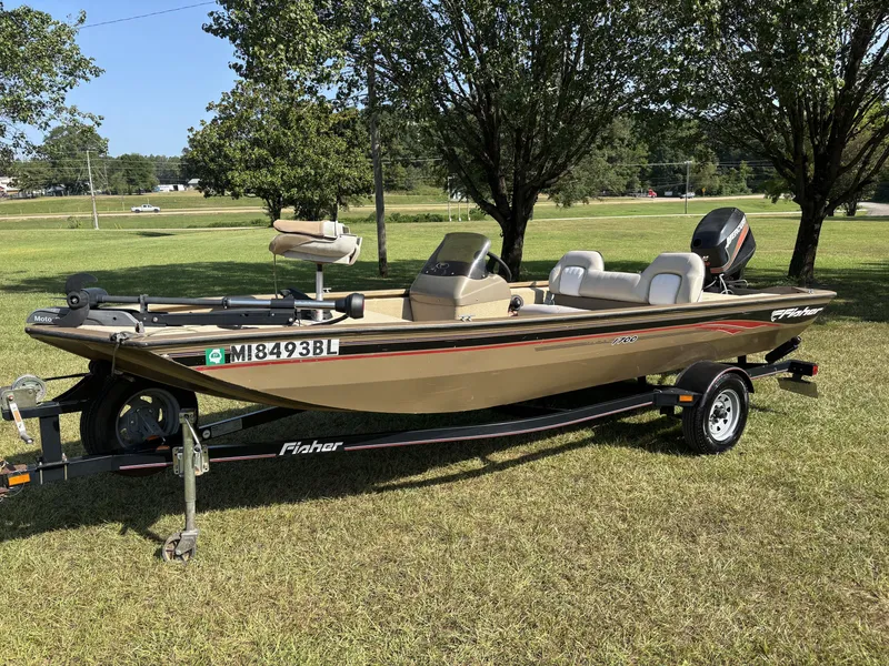 Slide: The Image of A 2006 Fisher Boats 1700 model sits on a trailer on a grassy field. - 5