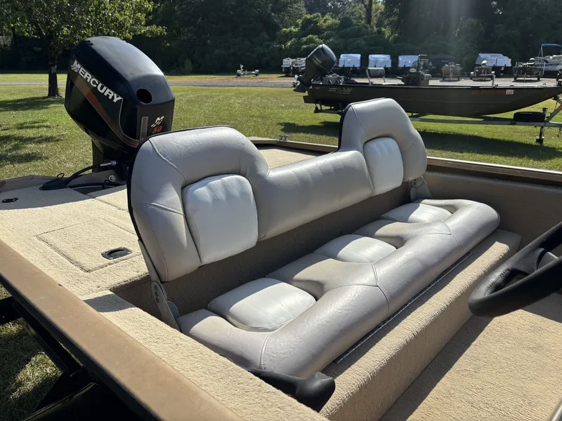 Slide: The Image of The image shows the interior of a Fisher boat with beige upholstery and a Mercury engine. - 15