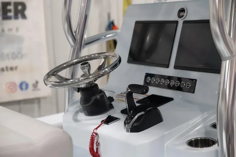 Slide: The Image of 2024 Contender 26 Bay boat console with dual screens and steering wheel. - 16