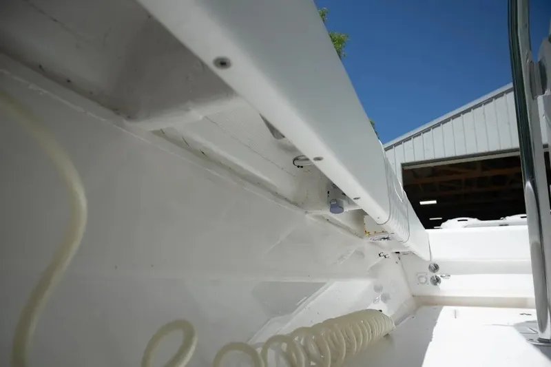 Slide: The Image of 2023 Contender 44 ST boat interior detail with coiled hose and storage compartment. - 20