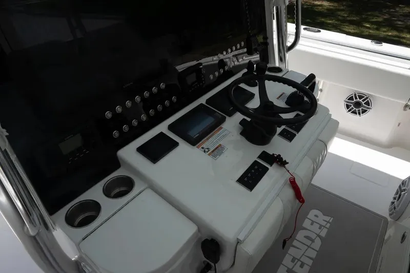 Slide: The Image of 2023 Contender 44 ST boat cockpit with steering wheel and control panel. - 12