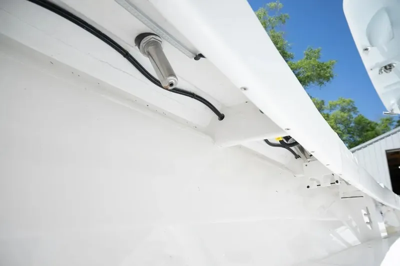 Slide: The Image of 2023 Contender 44 ST boat interior wiring detail under bright blue sky. - 19