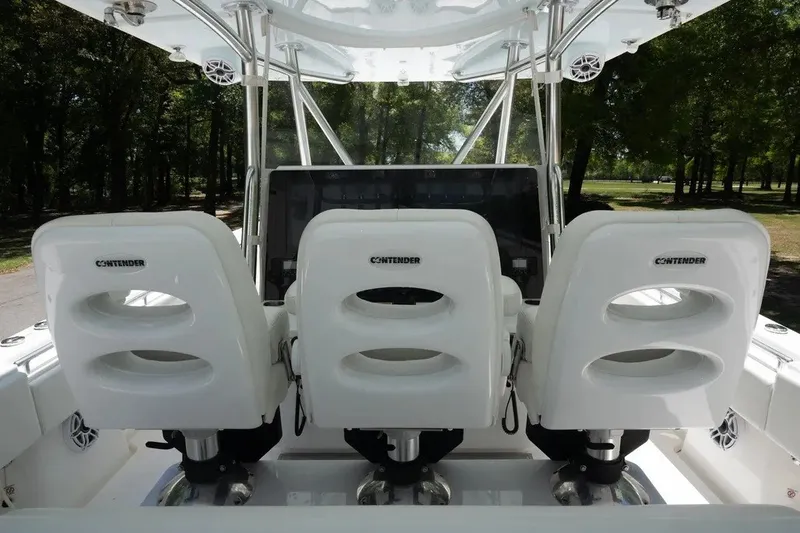 Slide: The Image of 2023 Contender 44 ST boat cockpit with three white seats and control panel. - 3