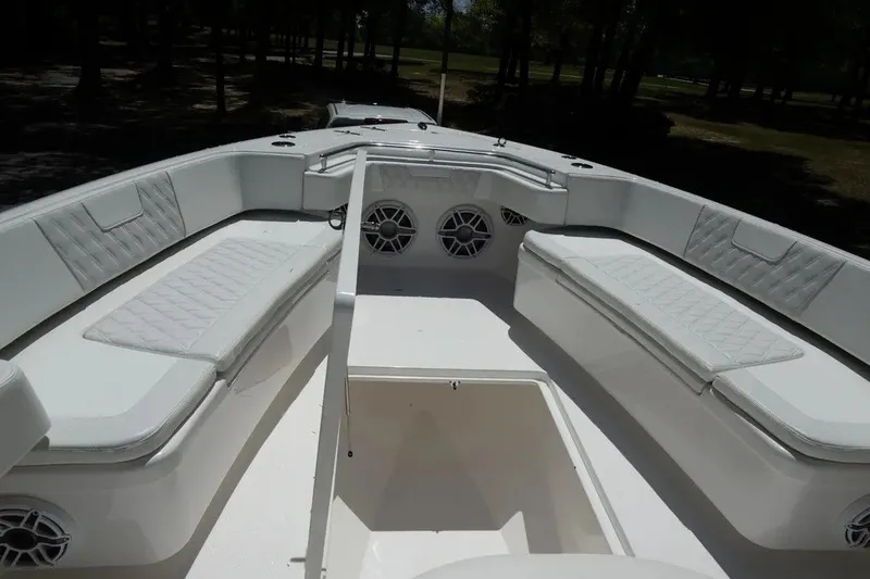 Slide: The Image of 2023 Contender 44 ST boat interior with cushioned seating and speakers. - 4