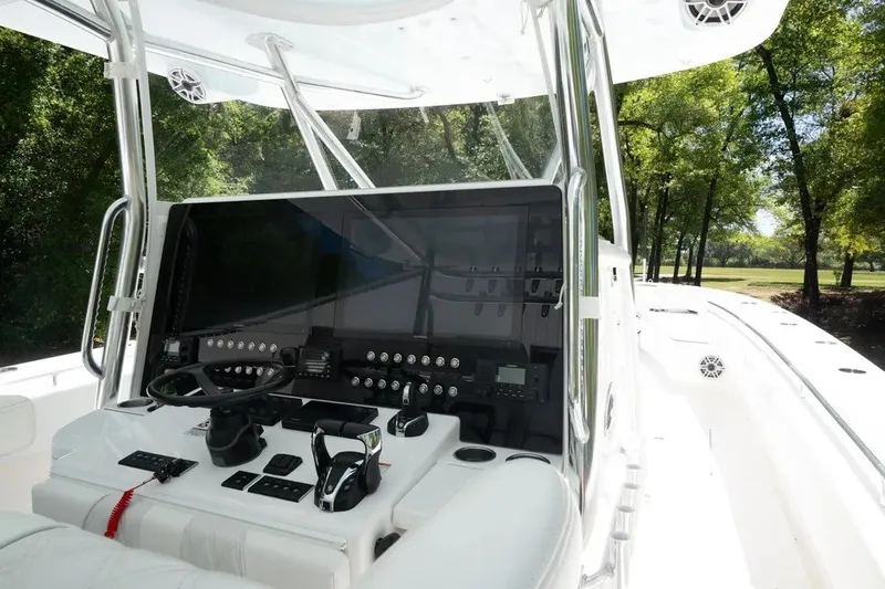 Slide: The Image of 2023 Contender 44 ST boat cockpit with advanced controls and sleek design. - 2