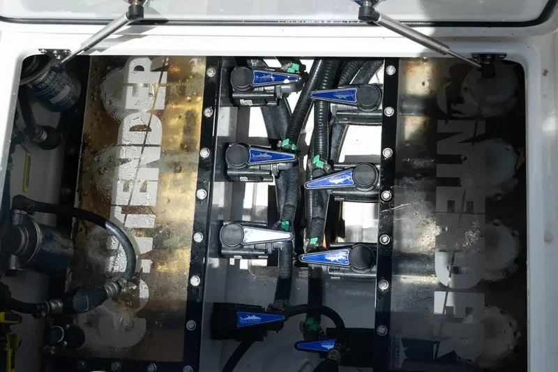 Slide: The Image of Engine compartment of 2023 Contender 44 ST boat, showcasing mechanical components and branding. - 10