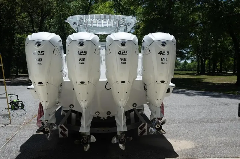 Slide: The Image of 2023 Contender 44 ST boat with four powerful Yamaha 425 V8 engines, parked outdoors. - 5