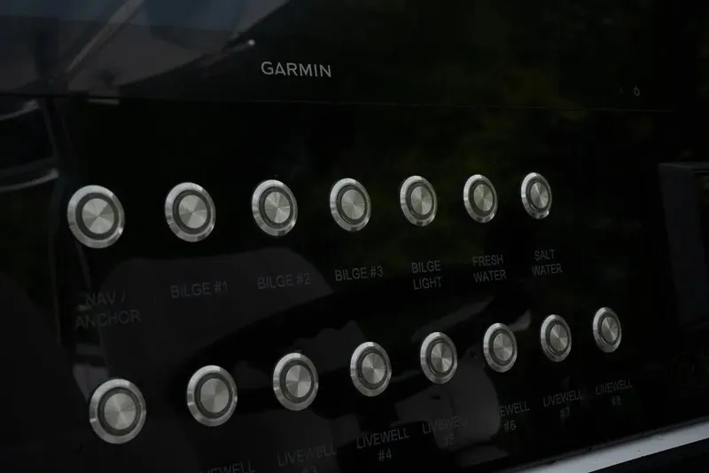 Slide: The Image of Control panel of 2023 Contender 44 ST boat with Garmin interface and labeled buttons. - 9