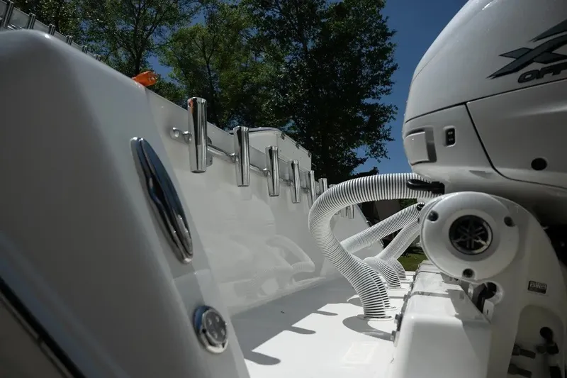 Slide: The Image of 2023 Contender 44 ST boat with Yamaha engine and rod holders, under clear blue sky. - 21