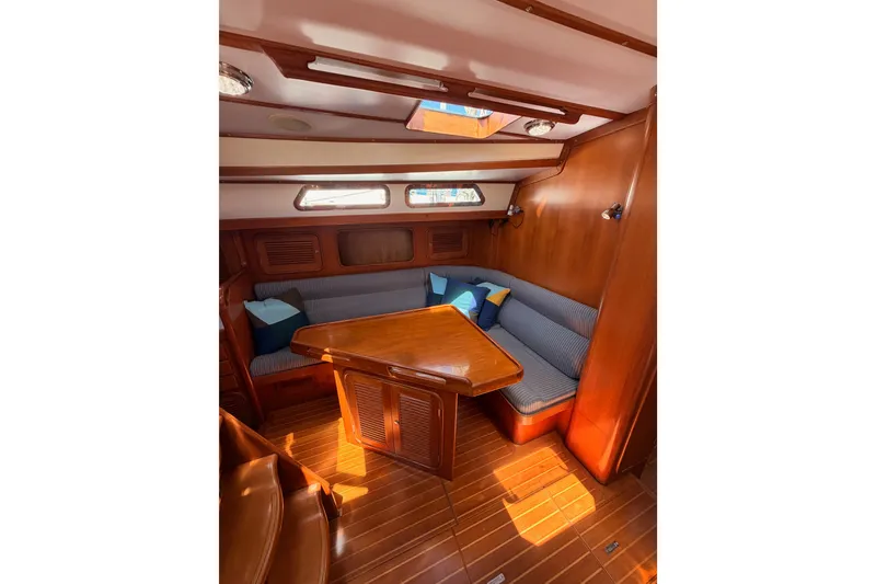 Slide: The Image of Interior of 2005 Tayana 48 yacht with wooden furnishings and cozy seating area. - 54