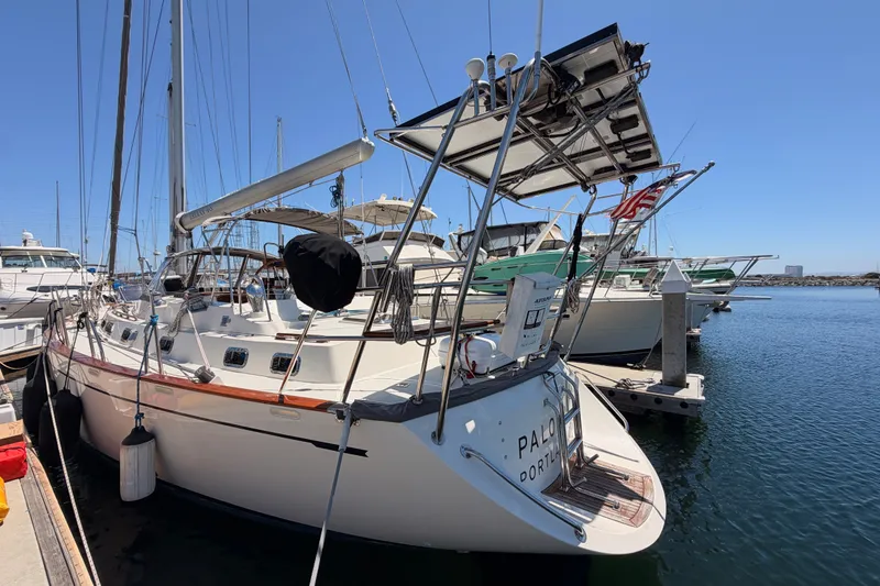 Slide: The Image of 2005 Tayana 48 sailboat docked at marina under clear blue sky. - 9