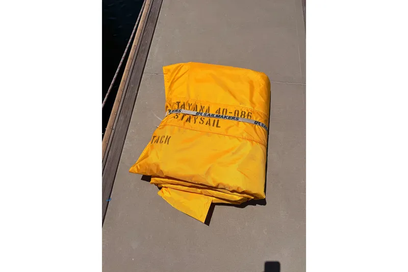 Slide: The Image of Yellow sail labeled "Tayana 48" on dock, 2005 model. - 124