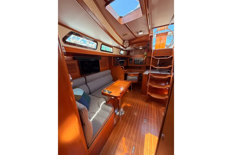 Slide: The Image of Luxurious 2005 Tayana 48 yacht interior with wood finish and comfortable seating. - 74