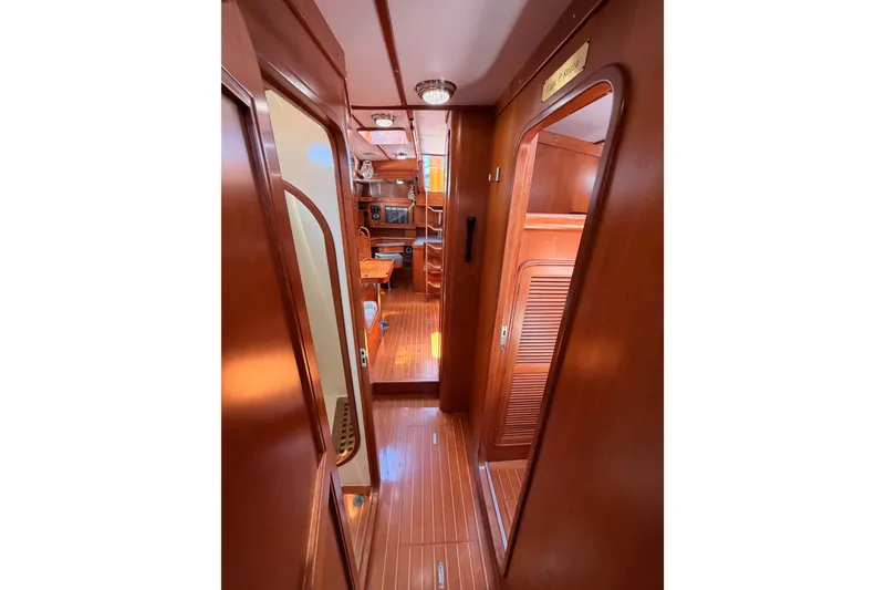 Slide: The Image of Interior view of 2005 Tayana 48 yacht, featuring polished wood finishes and cozy cabin layout. - 73
