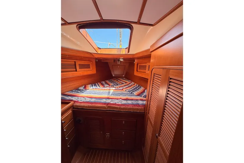 Slide: The Image of Cozy cabin interior of 2005 Tayana 48 yacht with wooden finish and colorful bedding. - 66