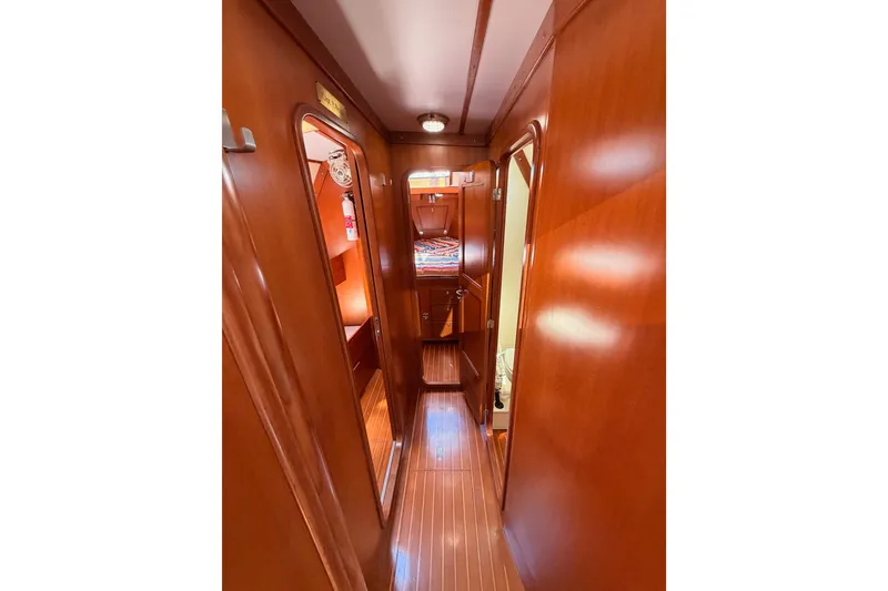 Slide: The Image of Interior hallway of 2005 Tayana 48 yacht with wooden finish and cabin access. - 58