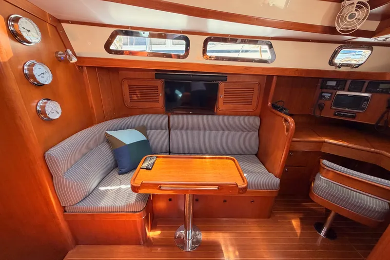 Slide: The Image of Luxurious 2005 Tayana 48 yacht interior with cozy seating and elegant wood finish. - 48