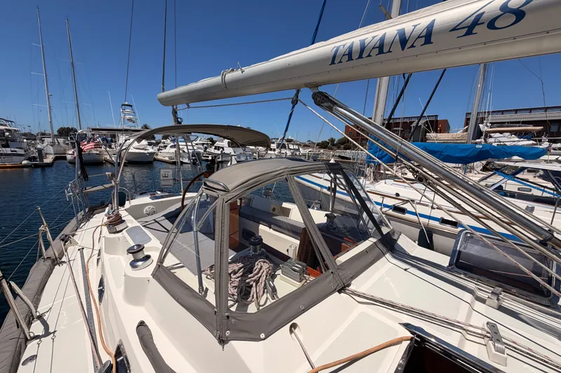 Slide: The Image of Sailboat Tayana 48, 2005 model, docked in a marina under clear blue skies. - 23
