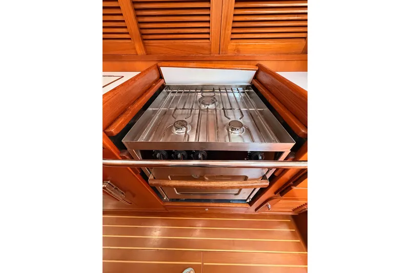 Slide: The Image of Stainless steel stove in 2005 Tayana 48 yacht galley with wooden cabinetry. - 79