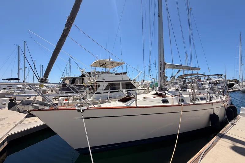 The Image of 2005 Tayana 48 sailboat docked at a marina under clear blue skies. - 0