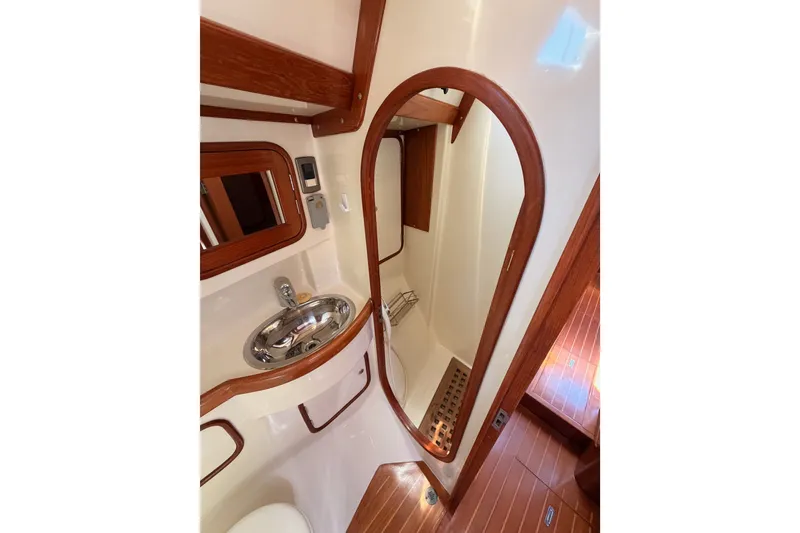 Slide: The Image of Interior of 2005 Tayana 48 yacht bathroom with wooden accents and stainless steel sink. - 60