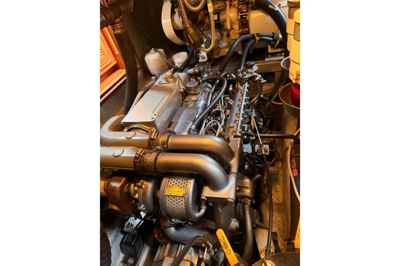 Slide: The Image of Engine compartment of a 2005 Tayana 48 yacht, showcasing detailed mechanical components. - 108