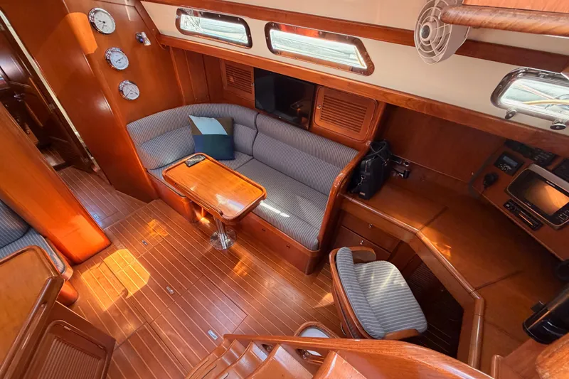 Slide: The Image of Luxurious 2005 Tayana 48 yacht interior with elegant wood finish and cozy seating area. - 47