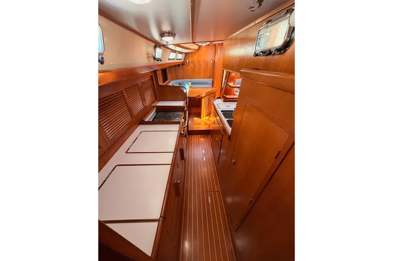 Slide: The Image of Interior of 2005 Tayana 48 yacht with wooden cabinetry and seating area. - 97