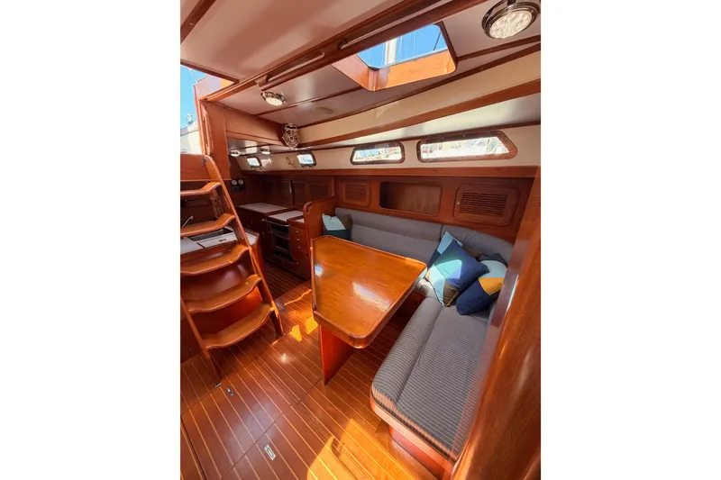 Slide: The Image of Interior of 2005 Tayana 48 yacht with wooden finish and cozy seating area. - 75