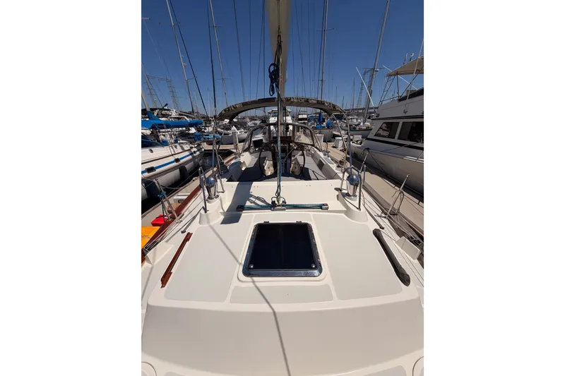 Slide: The Image of 2005 Tayana 48 sailboat deck view in marina, surrounded by other boats. - 31