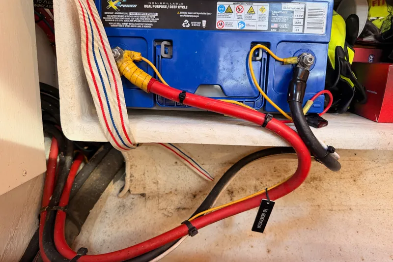 Slide: The Image of Battery compartment of a 2005 Tayana 48 sailboat with cables and connections. - 117
