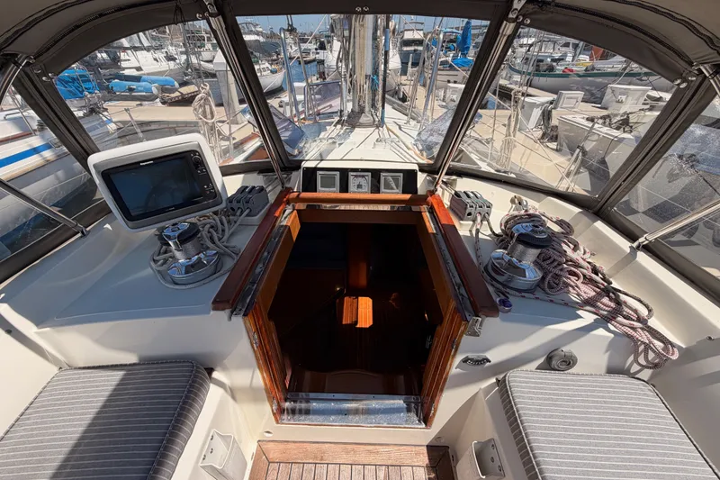 Slide: The Image of Cockpit of 2005 Tayana 48 sailboat with navigation equipment and marina view. - 40