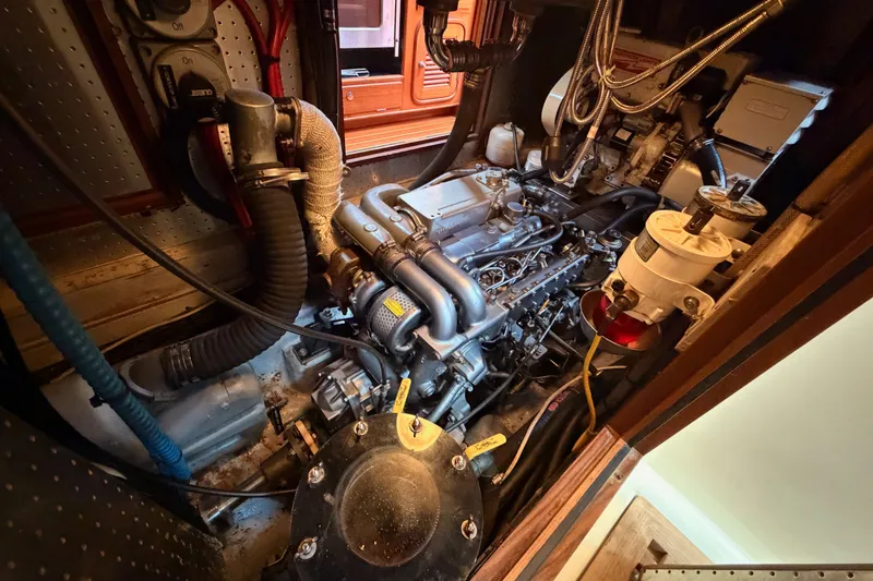 Slide: The Image of Engine room of a 2005 Tayana 48 yacht, showcasing detailed mechanical components. - 106