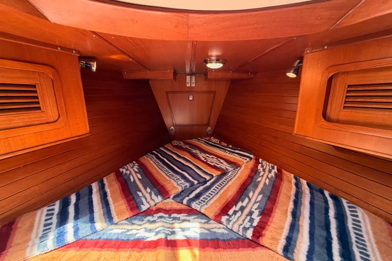 Slide: The Image of Cozy cabin interior of 2005 Tayana 48 sailboat with colorful bedding and wooden finish. - 71