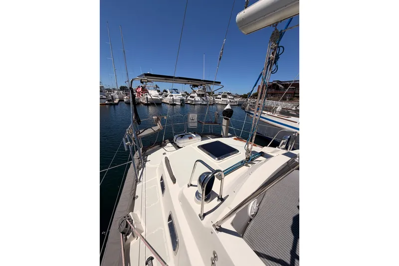 Slide: The Image of Sailboat Tayana 48, 2005 model, docked in a marina under clear blue skies. - 25
