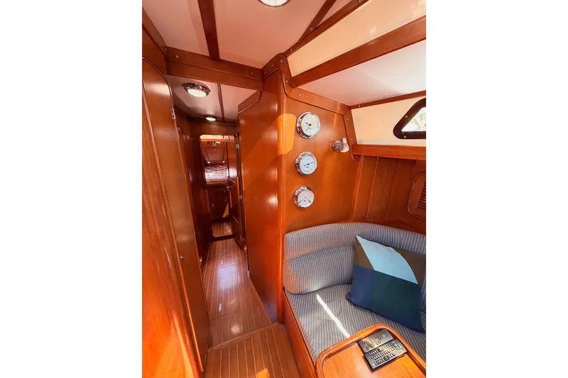 Slide: The Image of Interior of 2005 Tayana 48 yacht with wooden finish and cozy seating area. - 57