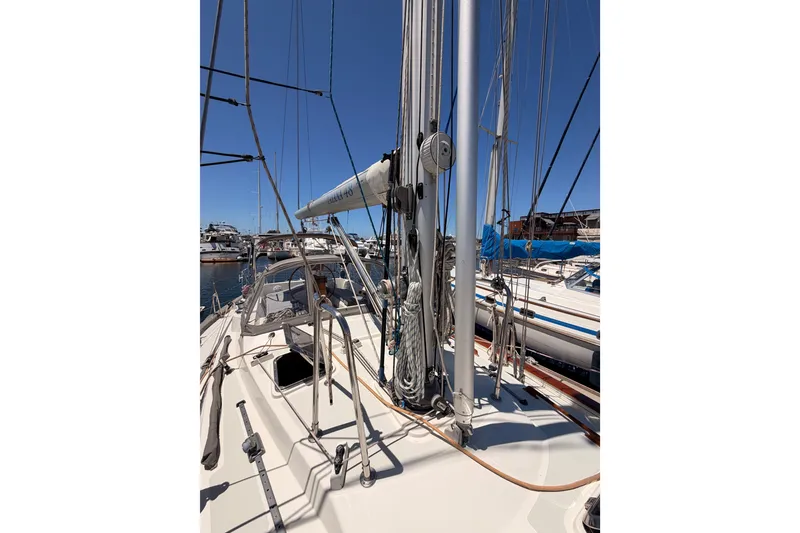 Slide: The Image of Sailboat deck view of 2005 Tayana 48, featuring mast and rigging in marina setting. - 21