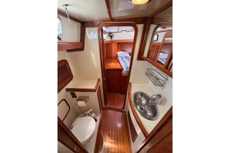 Slide: The Image of Luxurious 2005 Tayana 48 yacht bathroom with wood accents and modern fixtures. - 94