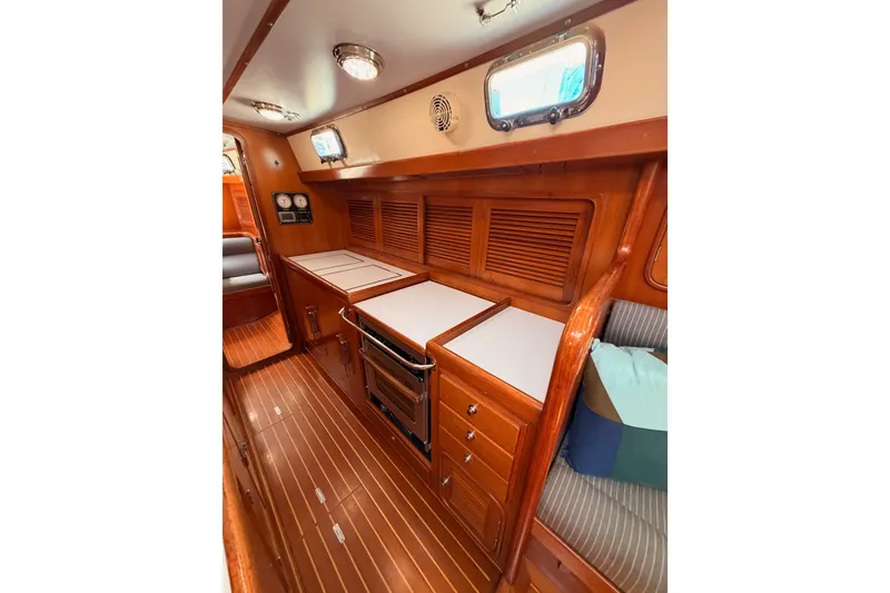 Slide: The Image of Luxurious 2005 Tayana 48 yacht interior with wooden cabinetry and modern kitchen amenities. - 78