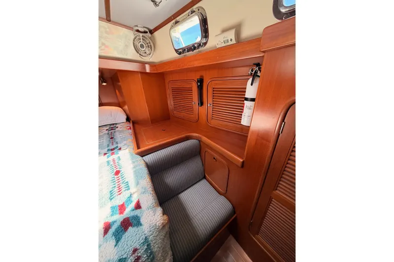 Slide: The Image of Cozy cabin interior of 2005 Tayana 48 yacht with wooden finish and colorful bedding. - 86