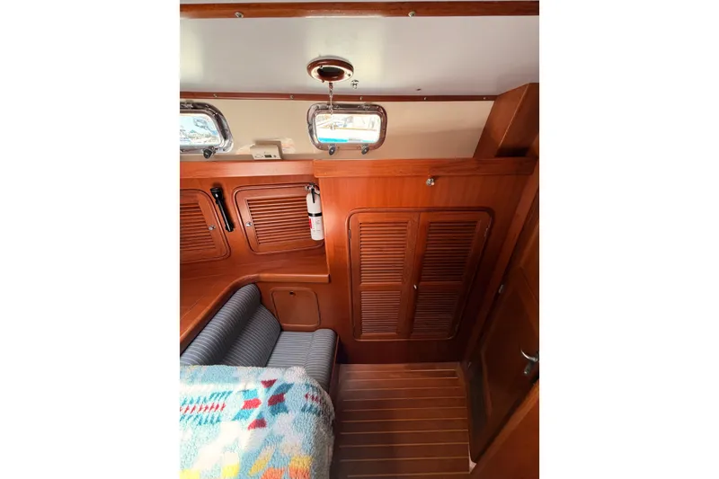 Slide: The Image of Interior of 2005 Tayana 48 yacht with wooden cabinetry and seating area. - 85