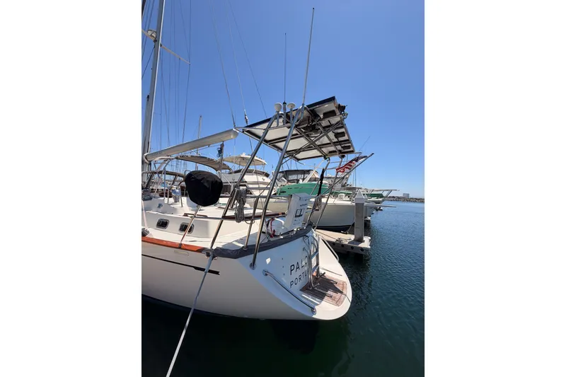 Slide: The Image of 2005 Tayana 48 sailboat docked at marina under clear blue sky. - 10