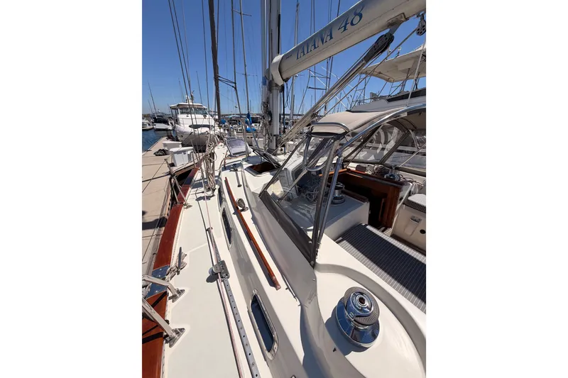 Slide: The Image of Sailboat Tayana 48, 2005 model, docked at marina with clear blue sky. - 12